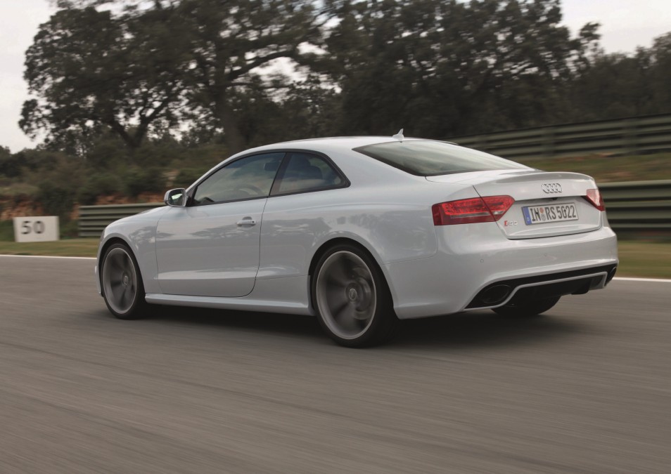Profile view of an Audi RS5 V8 driving on a mountain road