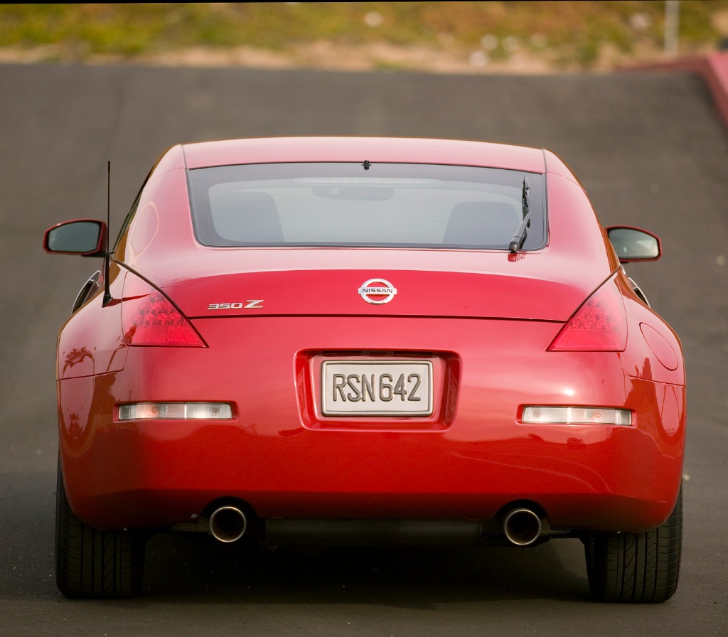 Rear view of a red Nissan 350Z Coupe 35th Anniversary special edition highlighting its wide stance and factory dual exhaust tips