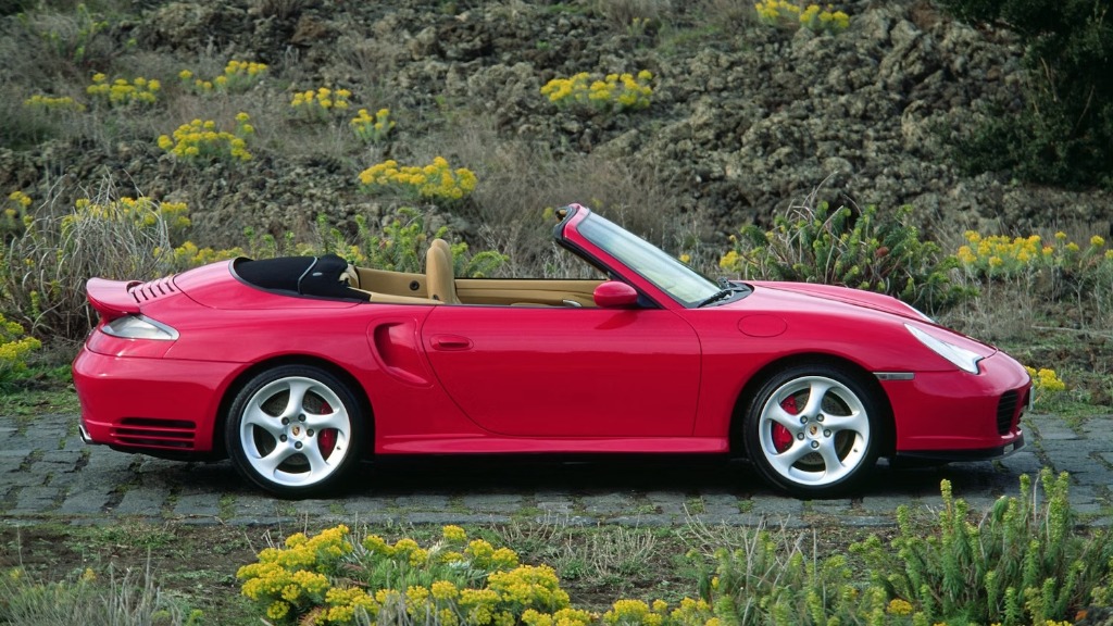 Red Porsche 911 (996) Turbo Cabriolet profile view with top down