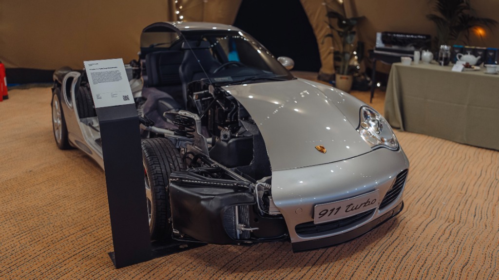 Official Porsche Museum cutaway showing the low-slung placement of water radiators and AC condensers inside the front bumper
